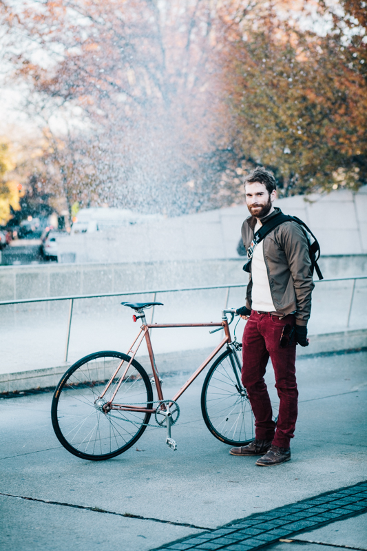 rides an unlabeled single-speed bicycle  photographed outside the Brooklyn Museum