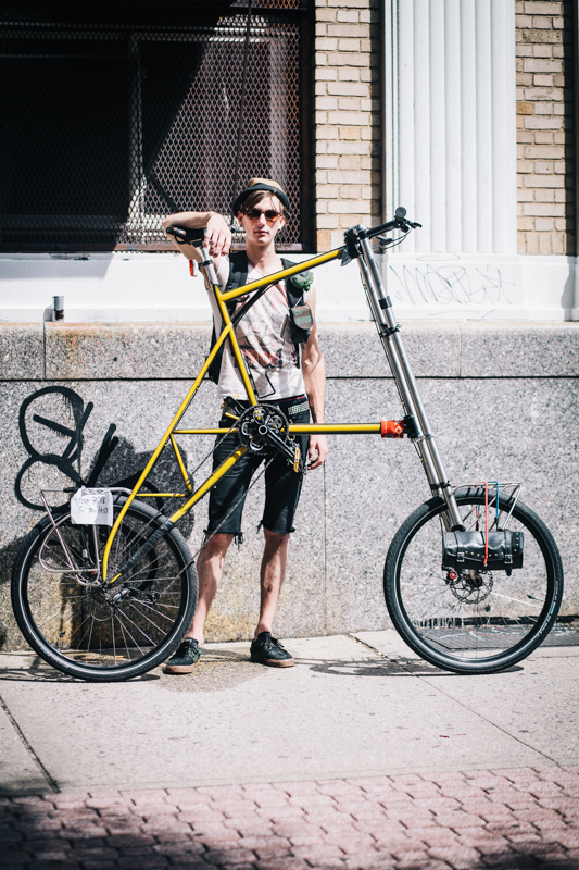 rides a custom tall bike by Hillel Eflal  photographed at Havemeyer St. and Grand St., Brooklyn  hanging out at the Bicyckle Fetish Day block party