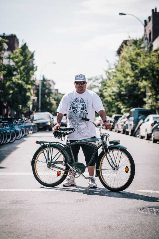 Miguel rides a vintage Schwinn cruiser bicycle photographed at Havemeyer St. and Grand St., Brooklyn  hanging out at the Bicycle Fetish Day block party