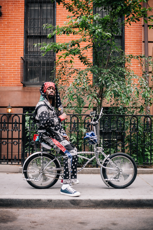 rides a Kenda silver twisted frame low-rider photographed at St. Felix St. and Lafayette Ave., Brooklyn  at the Dance Africa Street Festival